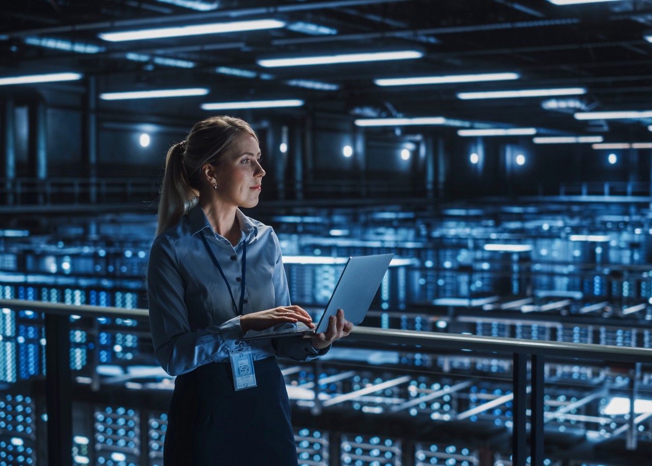Data Center Female It Specialist Using Laptop. Server Farm Cloud Computing and Cyber Security Maintenance Administrator Working on Computer. Information Technology Professional. Data Center Female It Specialist Using Laptop. Server Farm Cloud Computing and Cyber Security Maintenance Administrator Working on Computer. Information Technology Professional.