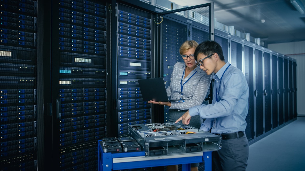 Colleagues working together to solve a problem in the data center Colleagues working together to solve a problem in the data center