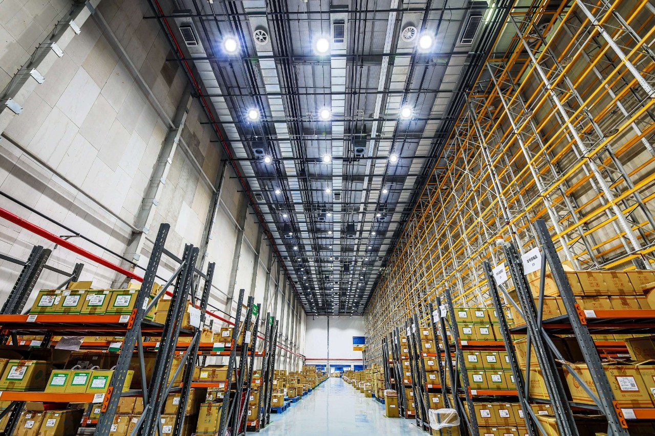 Full warehouse with stacked shelves to represent automating business processes.