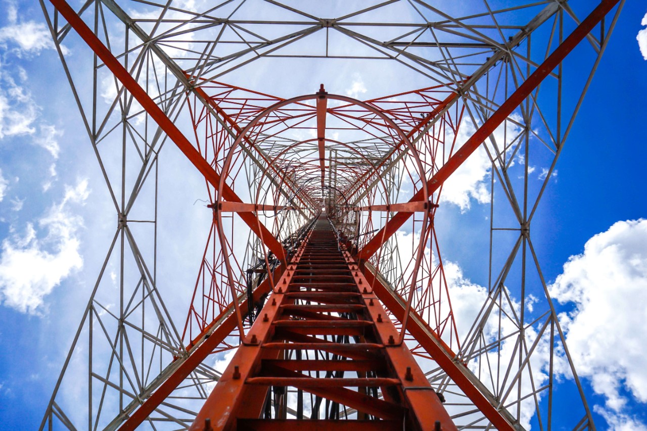A radio tower view from underneath it to represent enterprise managed services.