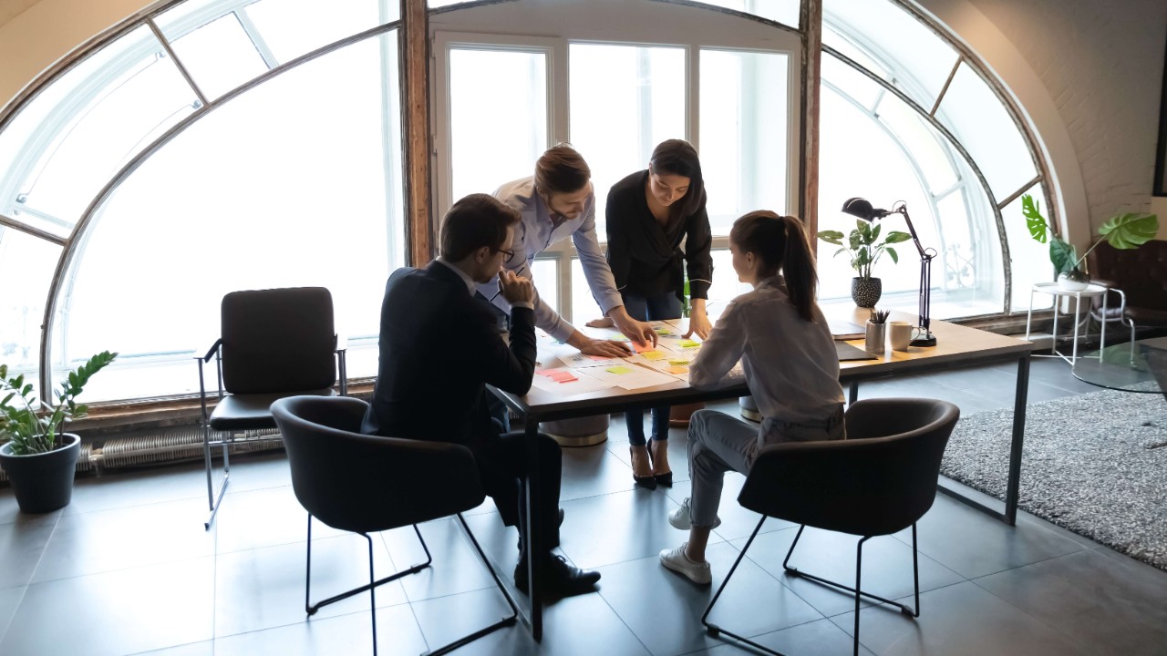 People working at a table to represent automating networks to deliver assured service experiences to provider customers. People working at a table to represent automating networks to deliver assured service experiences to provider customers.